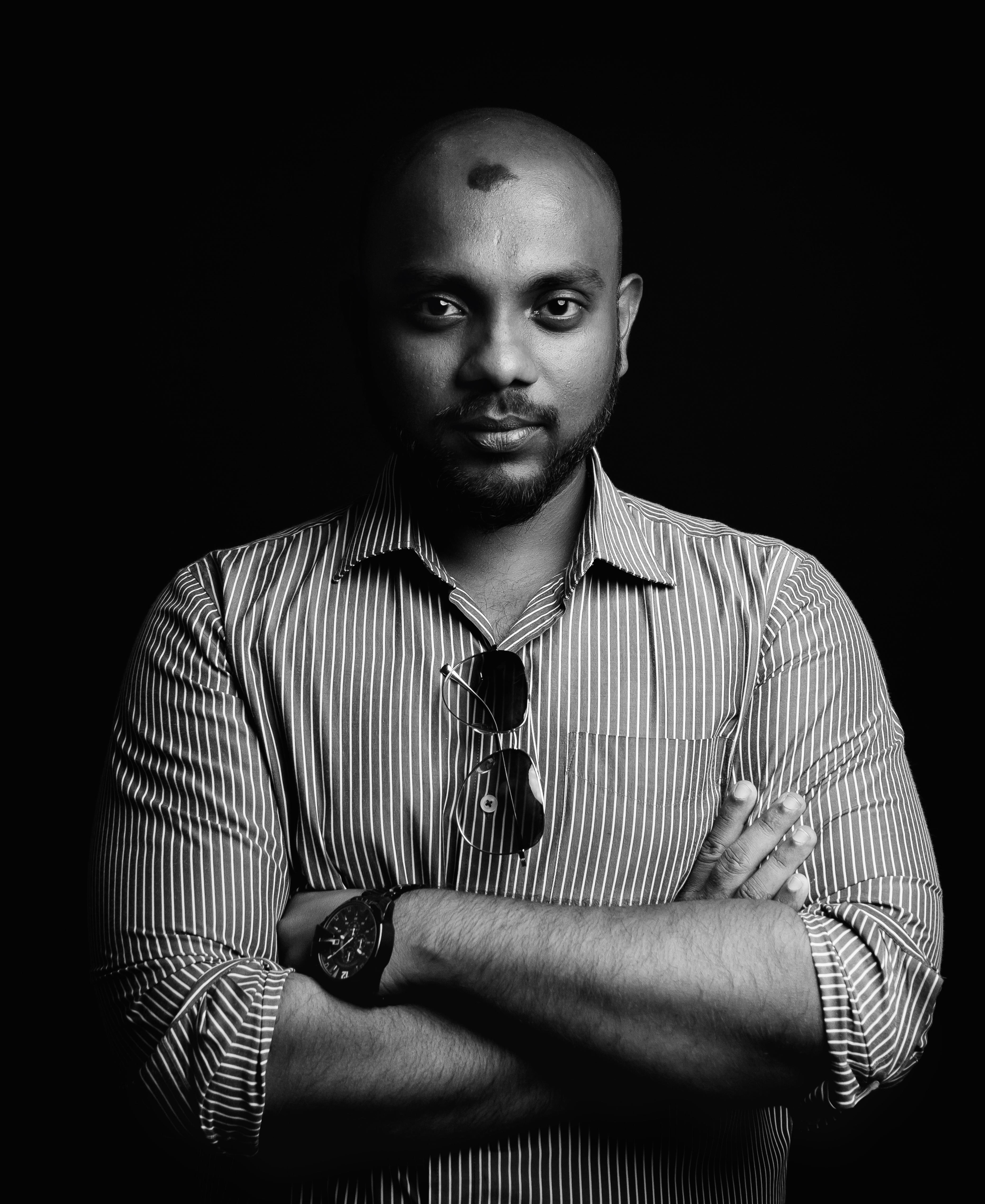 gray scale image of jerin sitting in his desk